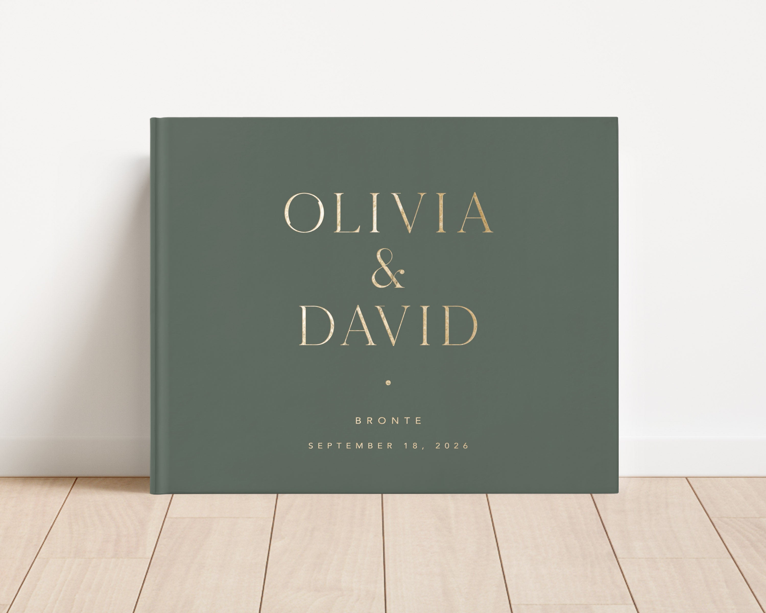 Luxury wedding guest book with custom gold foil text and moss hardback cover.