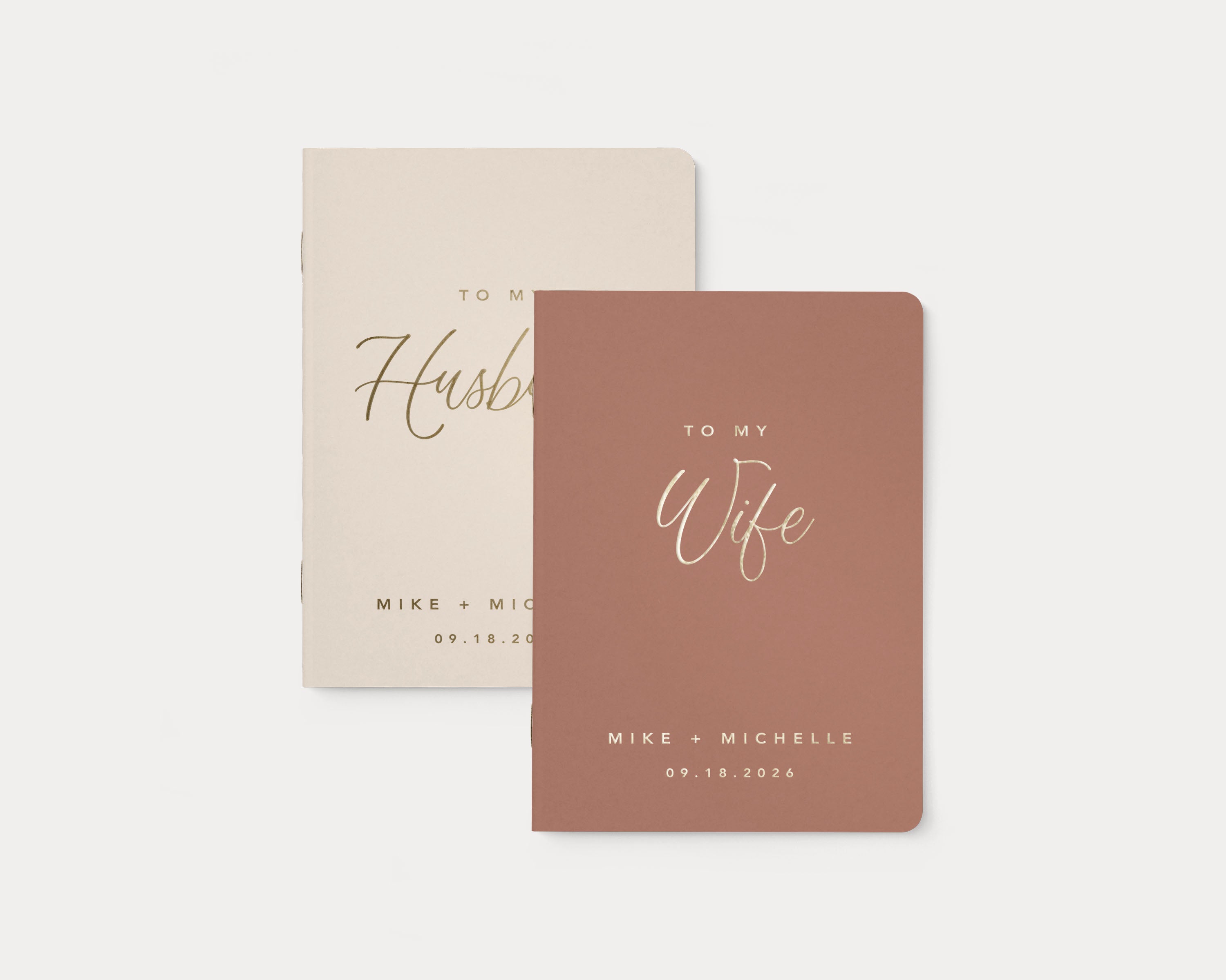 Set of 2 wedding vow books with gold foil personalization.