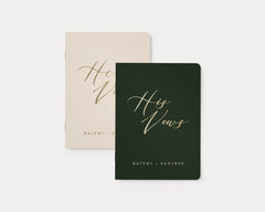 Almond and moss wedding vow books with custom gold foil lettering.