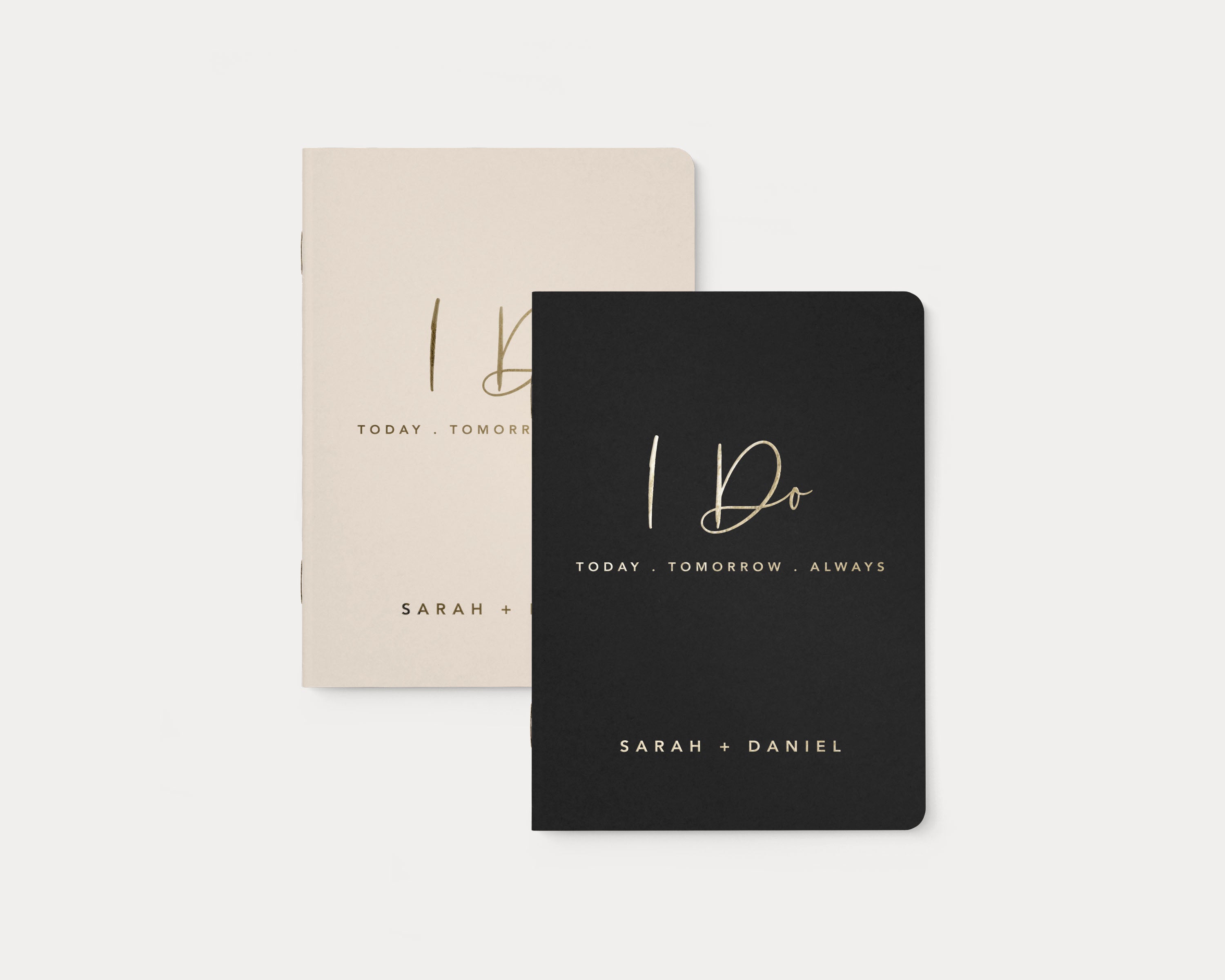 Set of 2 wedding vow books with gold foil personalization.