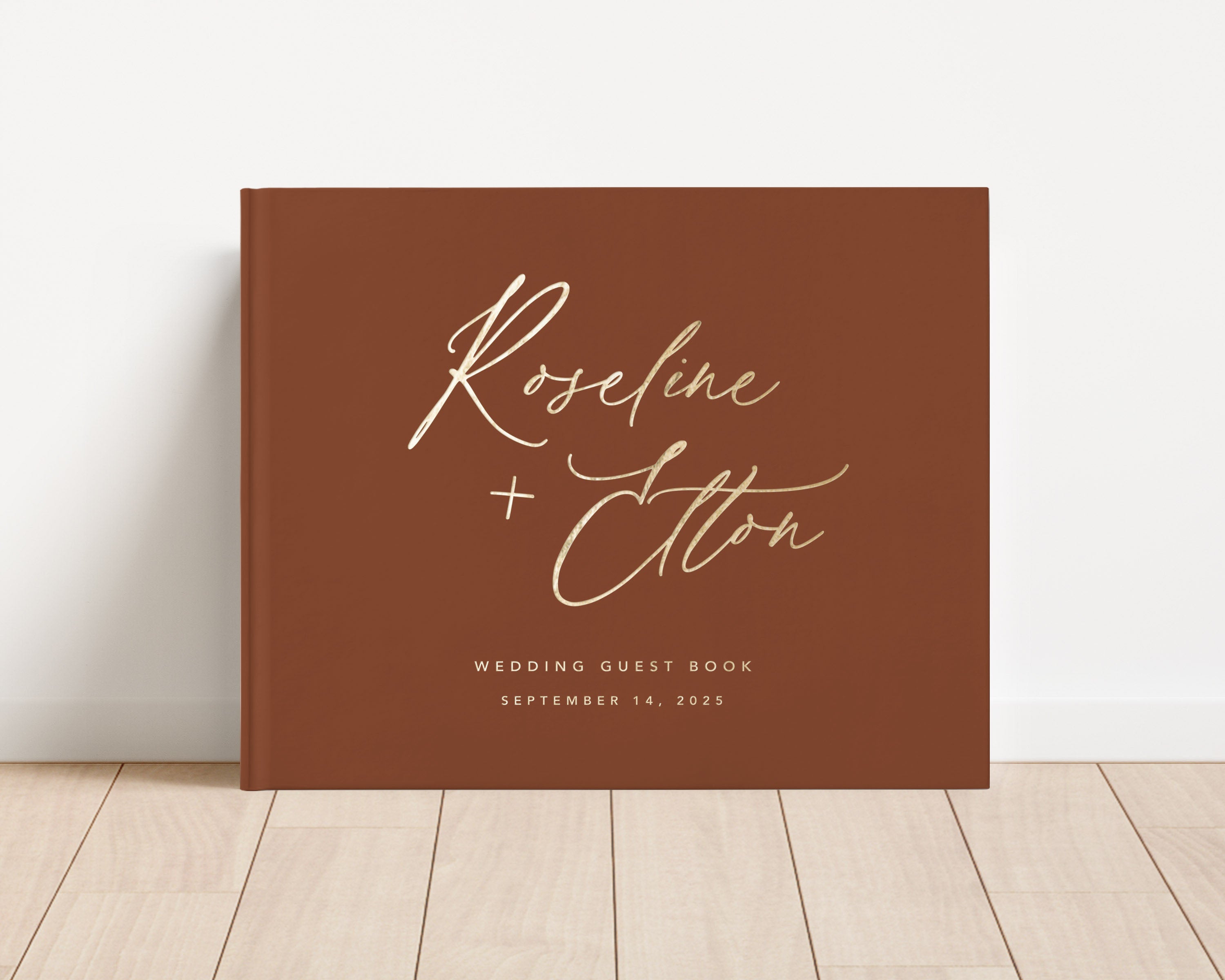 Luxury wedding guest book with custom gold foil text and terracotta hardback cover.