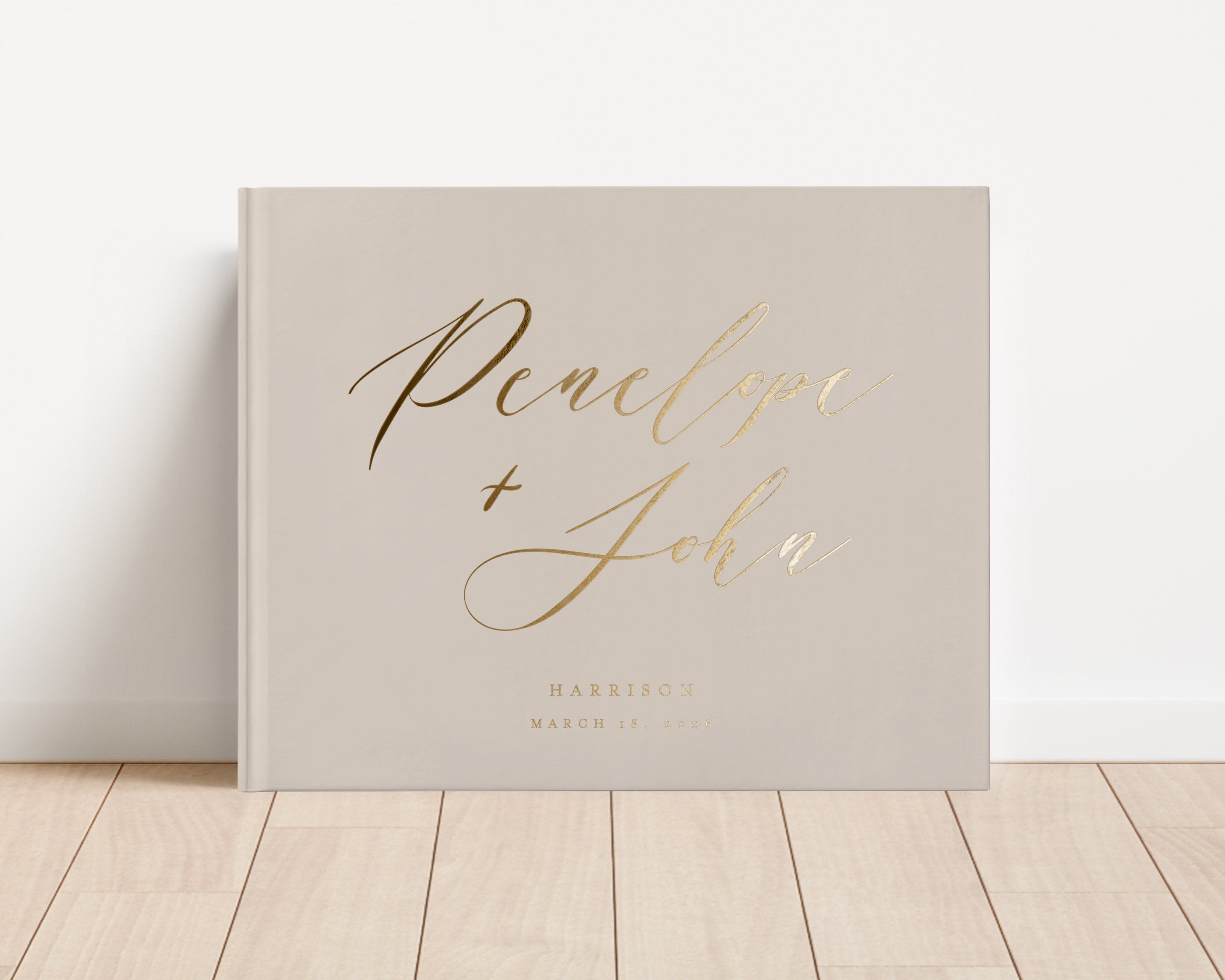 Custom hardback wedding guest book personalized with luxury gold foil text.