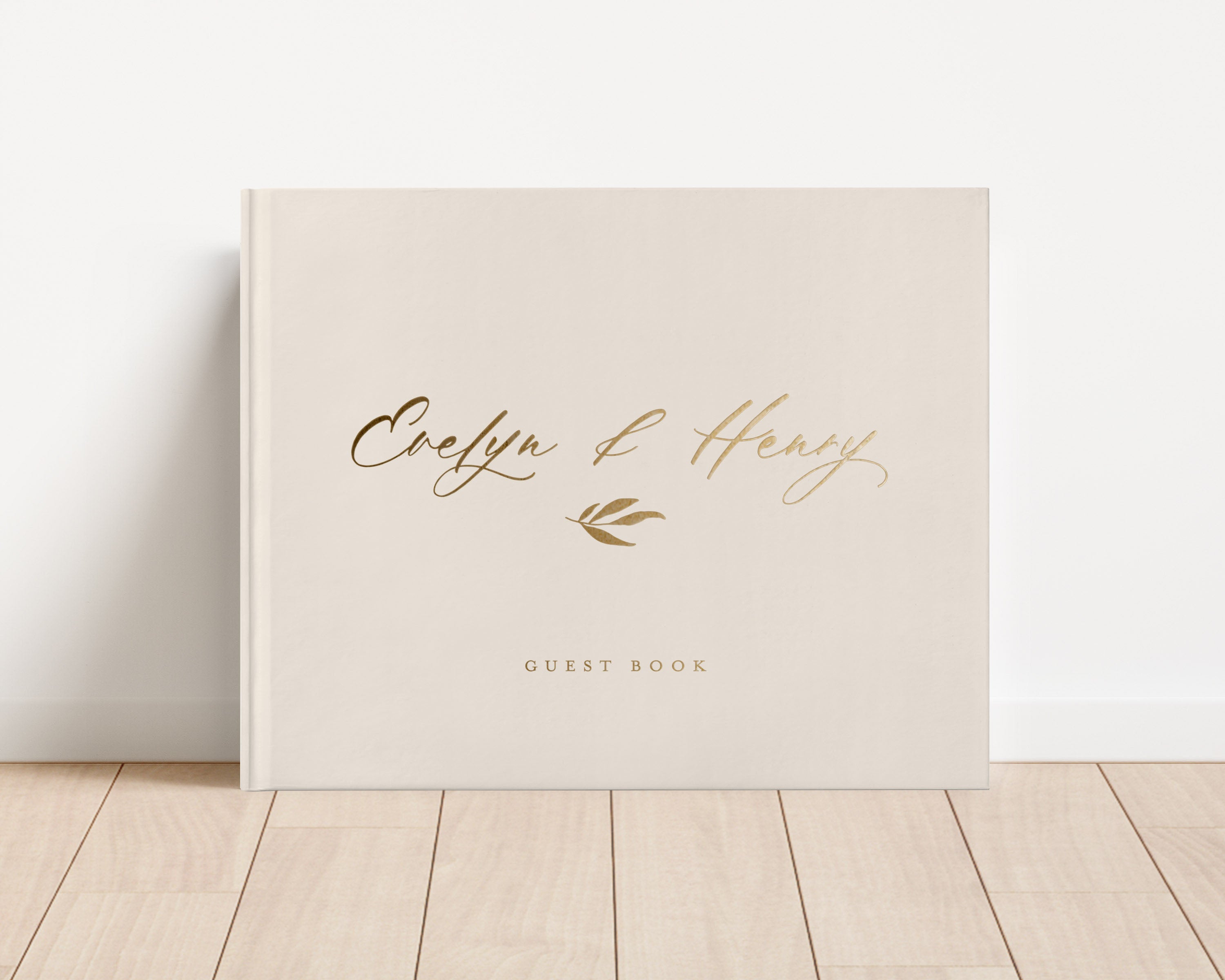 Custom hardback wedding guest book personalized with luxury gold foil text.