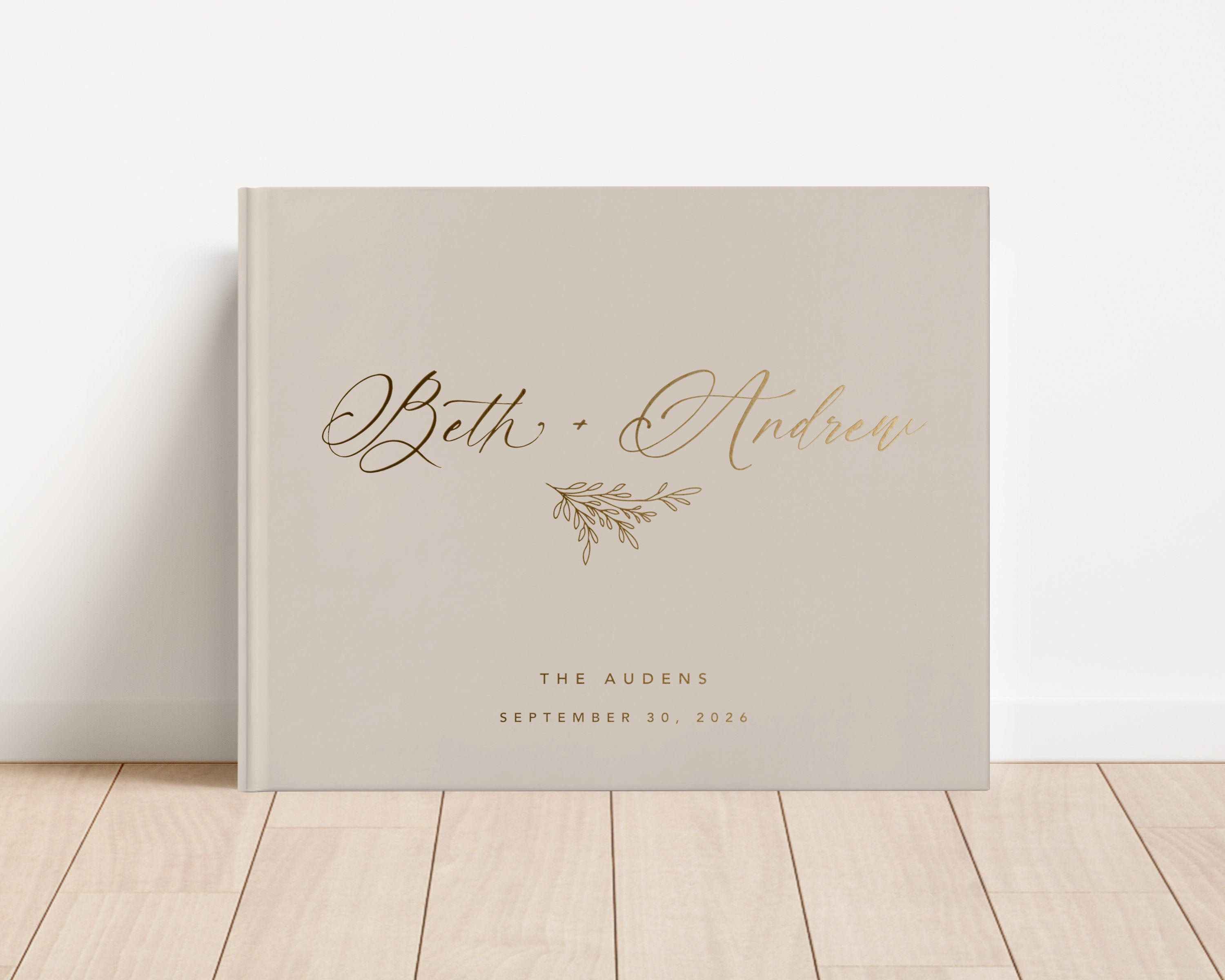 Custom hardback wedding guest book personalized with luxury gold foil text.