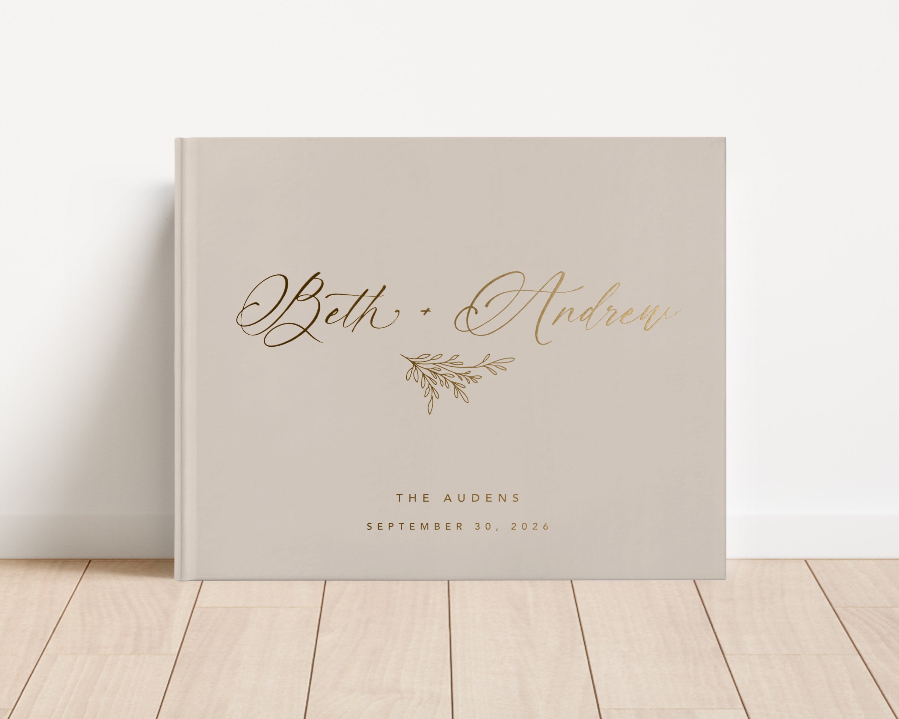Custom hardback wedding guest book personalized with luxury gold foil text.