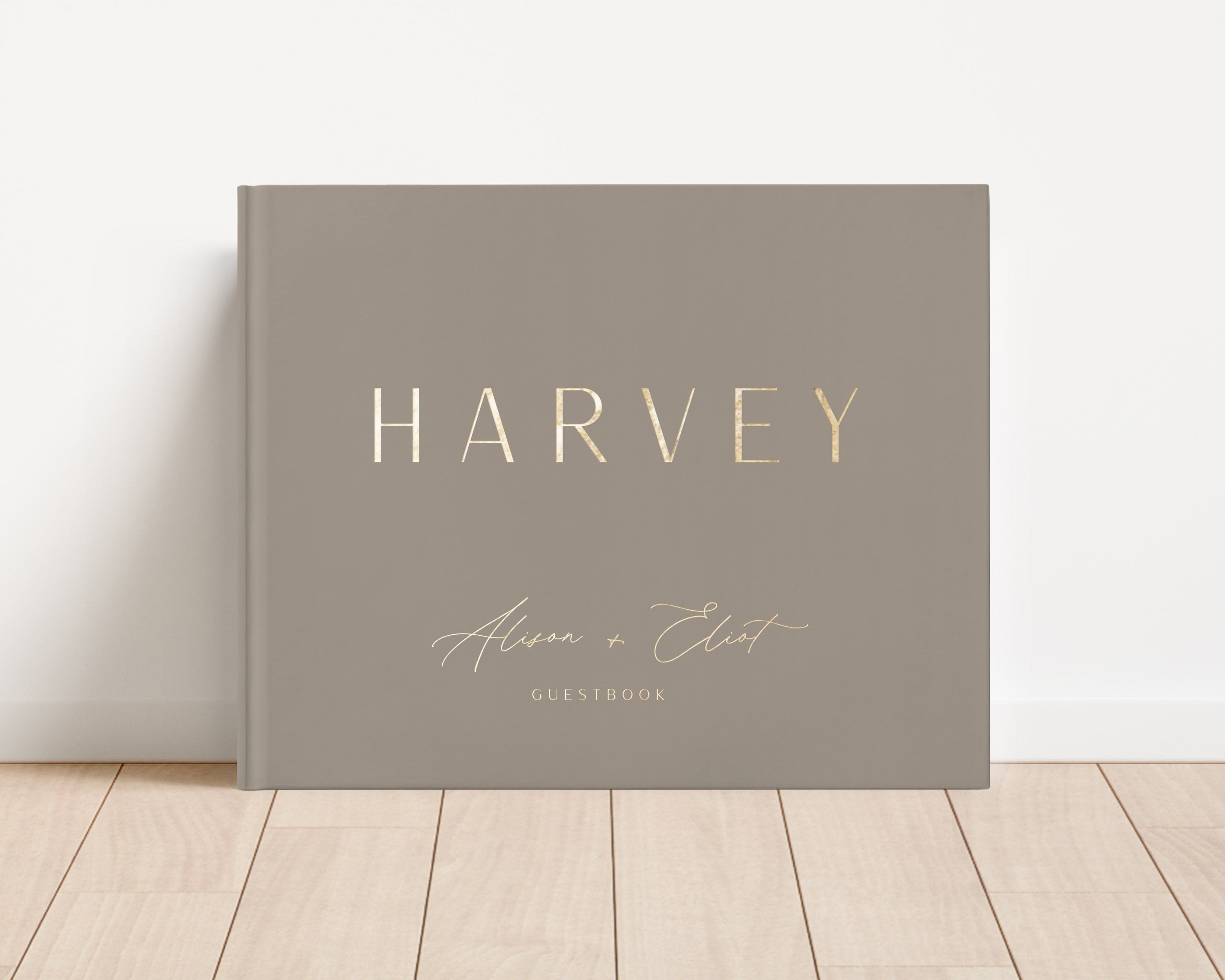 Custom hardback wedding guest book personalized with luxury gold foil text.
