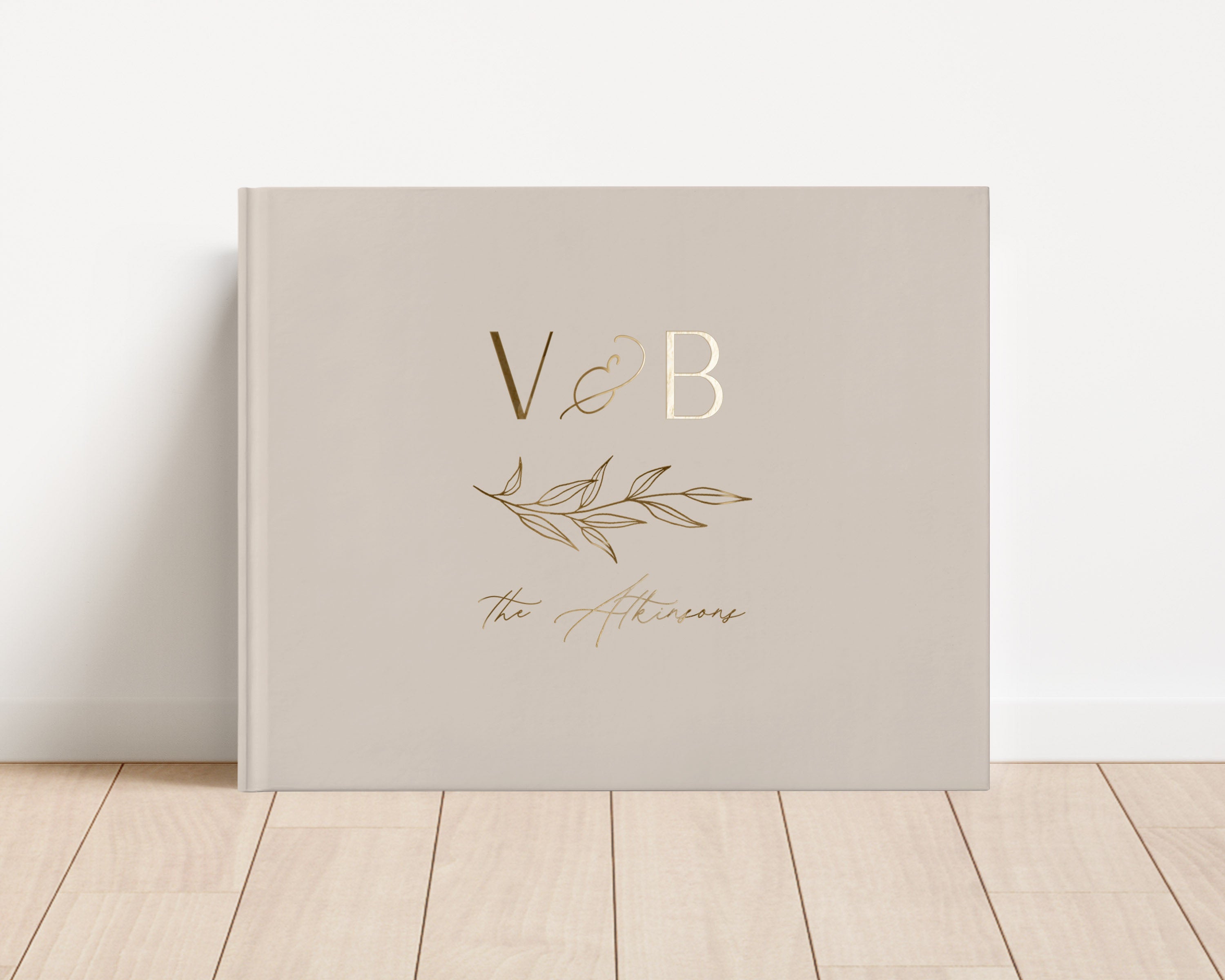 Custom hardback wedding guest book personalized with luxury gold foil text.