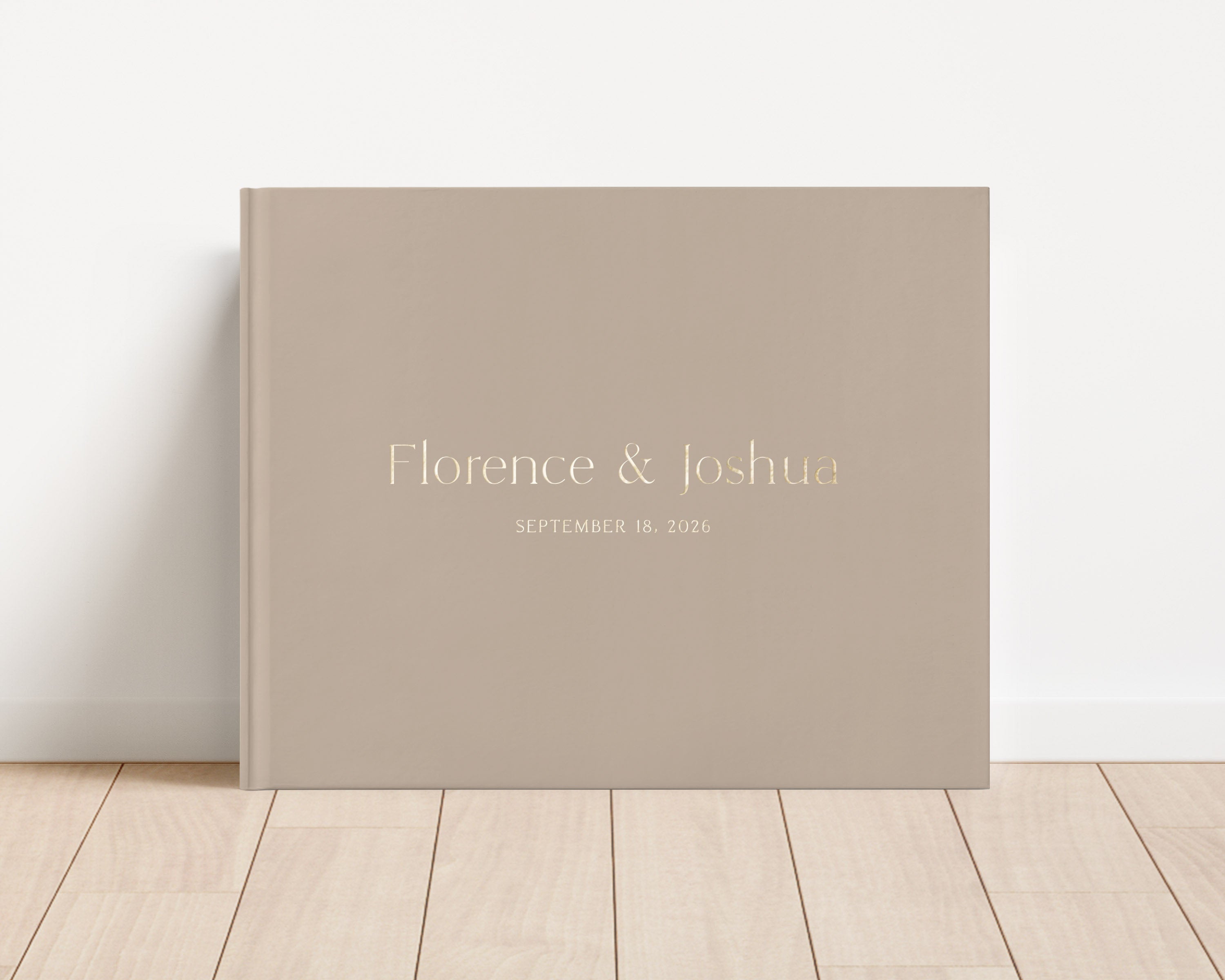 Custom hardback wedding guest book personalized with luxury gold foil text.