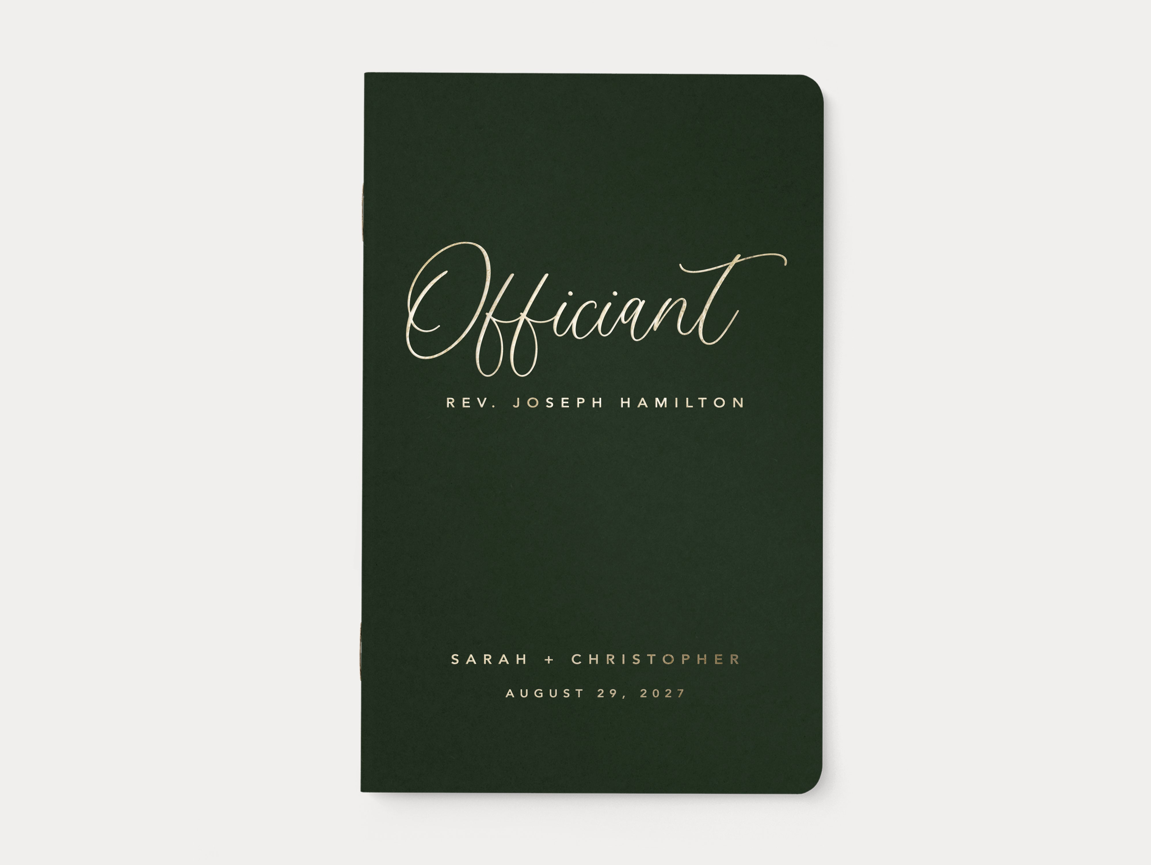 Luxury gold foil wedding officiant book with green cover.