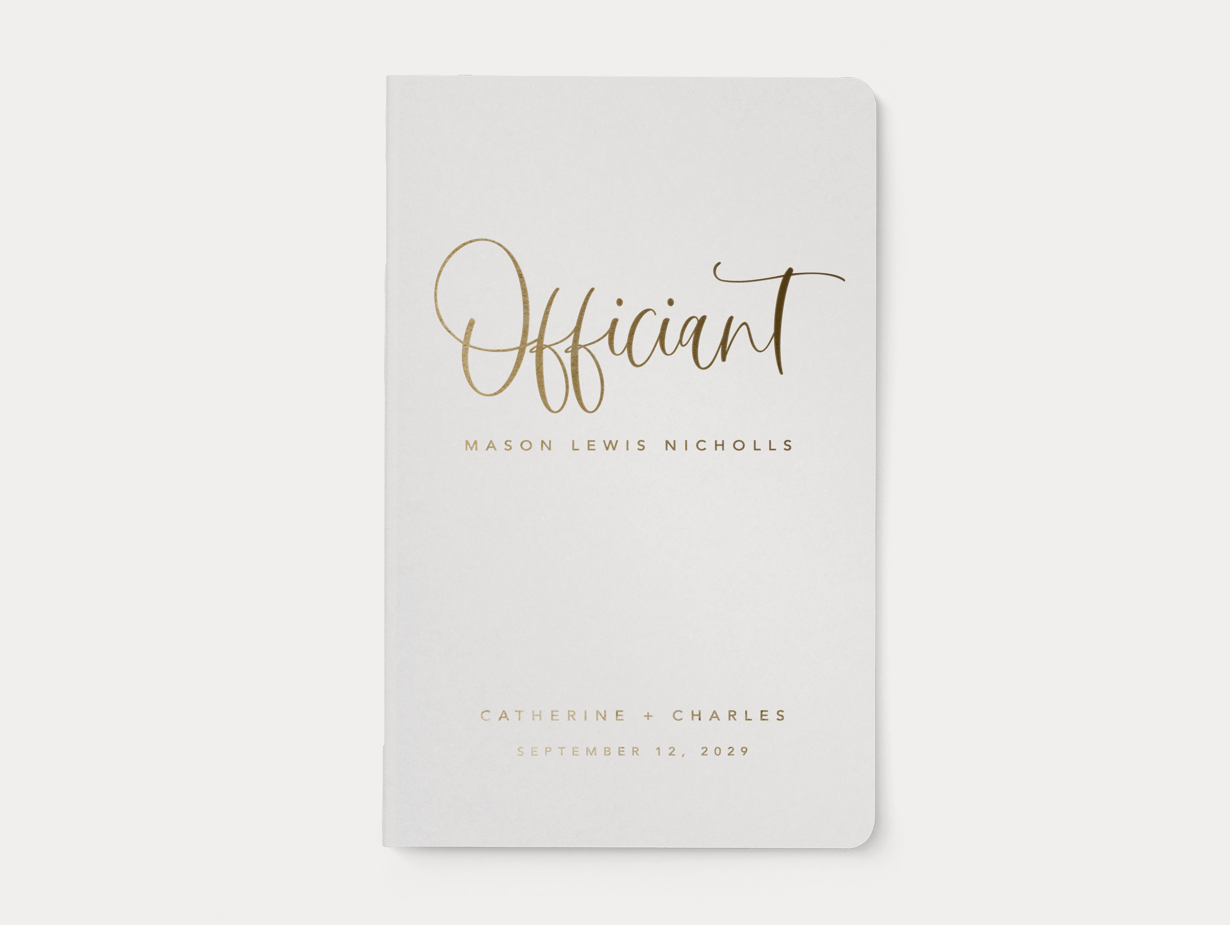 Classic wedding officiant book with white cover and gold foil text.