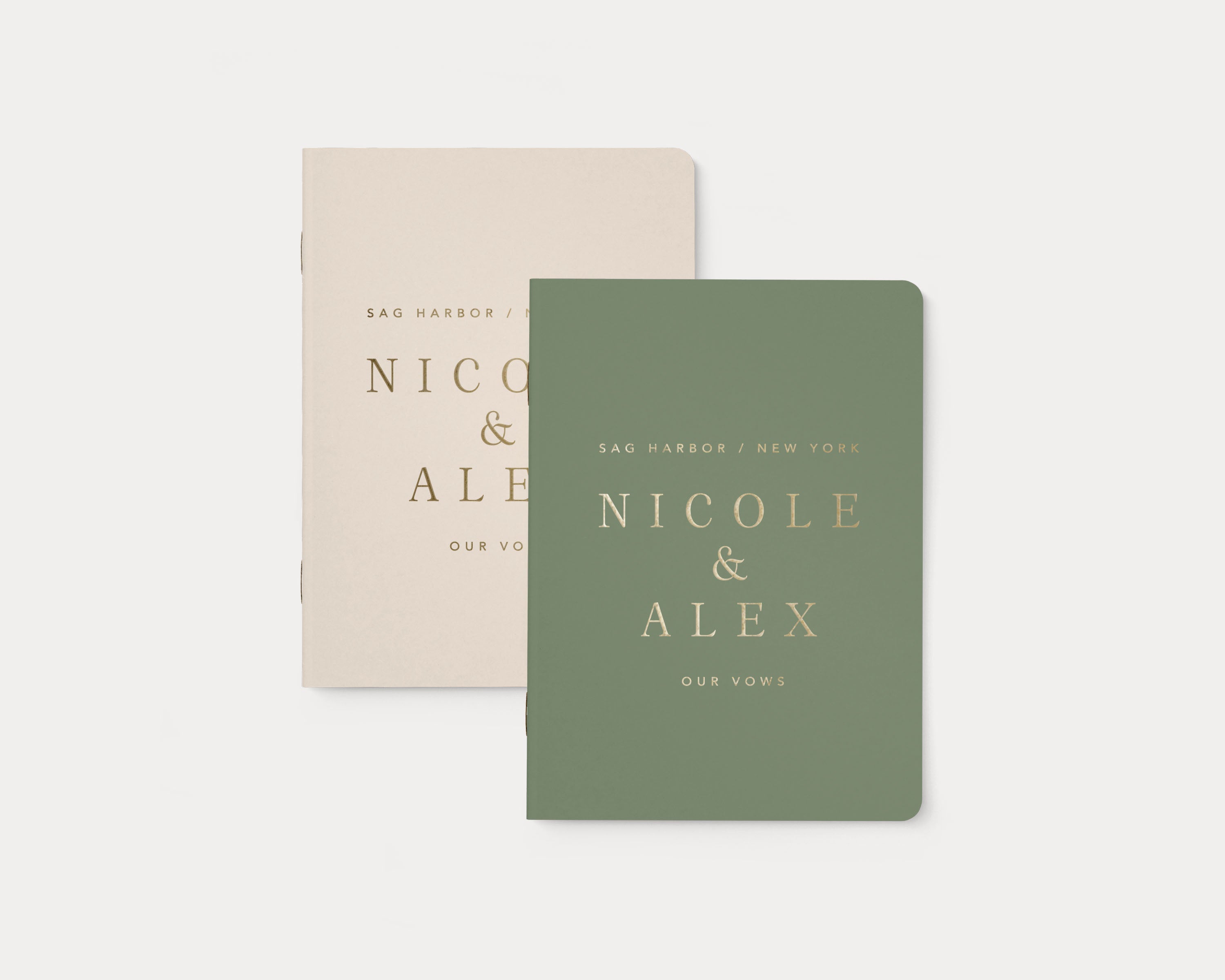 Ivory and sage wedding vow books with custom gold foil lettering.