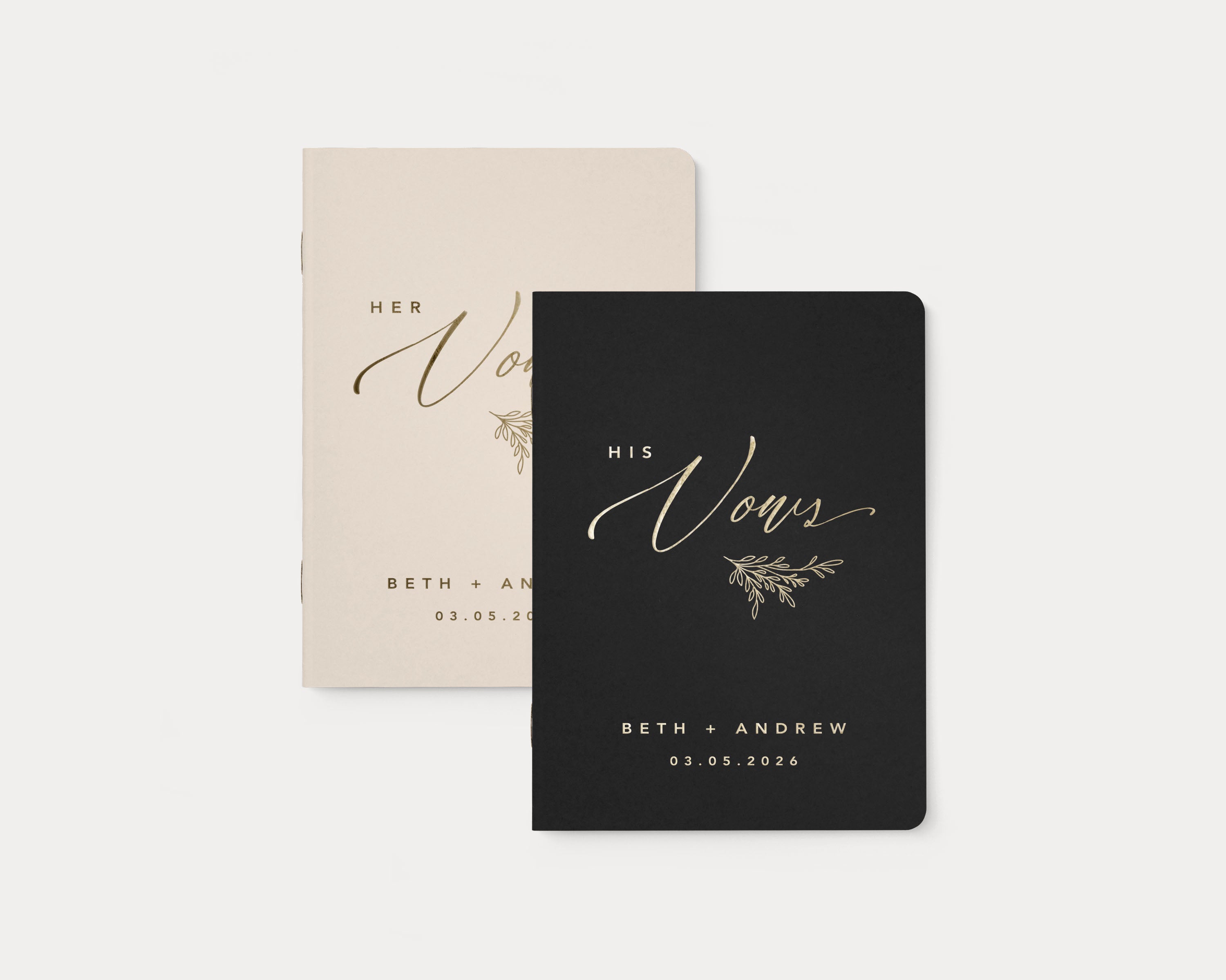Almond and black wedding vow books with custom gold foil lettering.