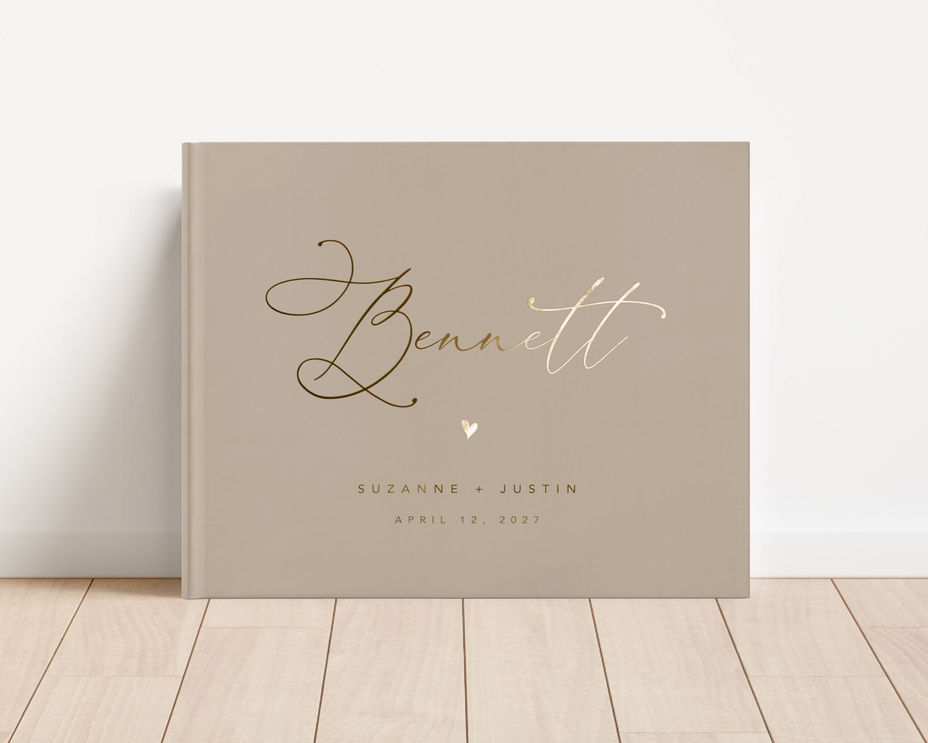 Custom hardback wedding guest book personalized with luxury gold foil text.