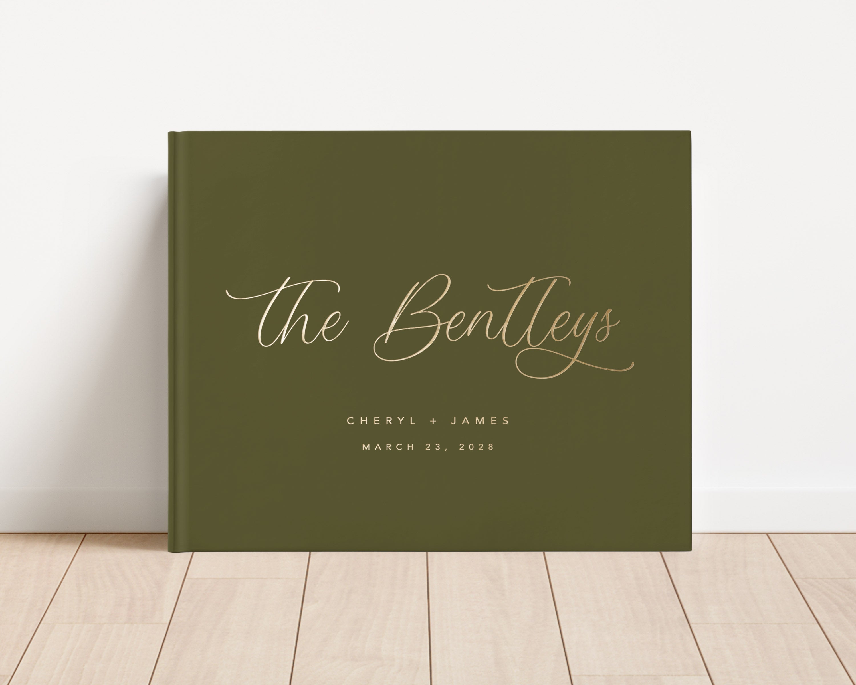 Luxury wedding guest book with custom gold foil text and green hardback cover.