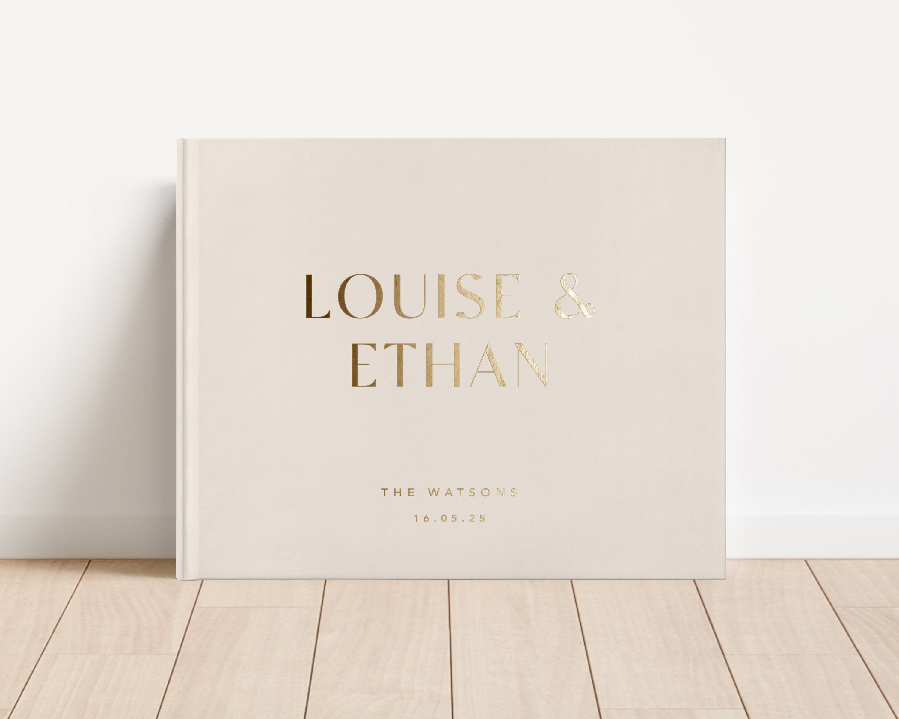 Luxury wedding guest book with custom gold foil text and cream hardback cover.