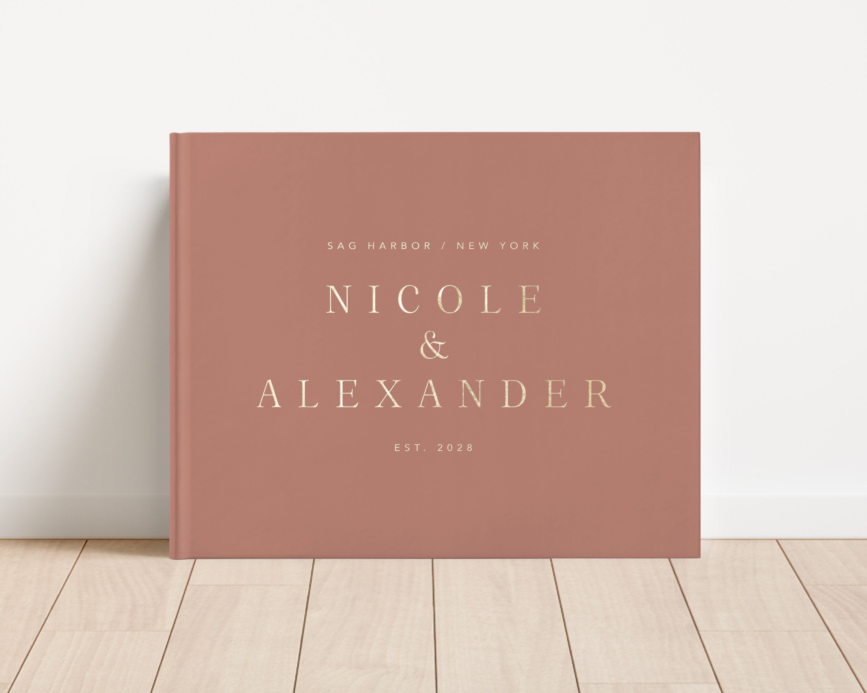 Luxury wedding guest book with custom gold foil text and clay hardback cover.
