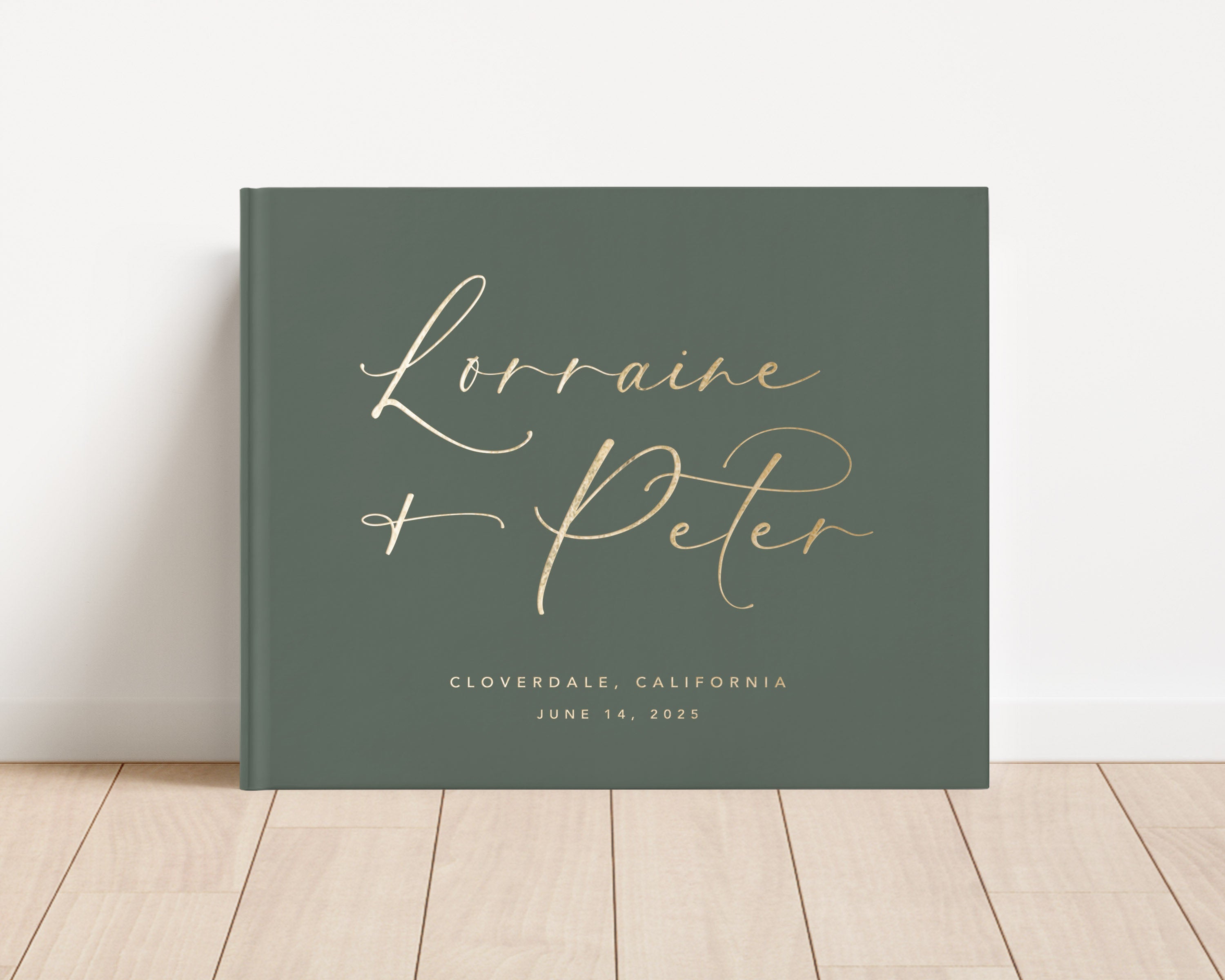 Luxury wedding guest book with custom gold foil text and green hardback cover.