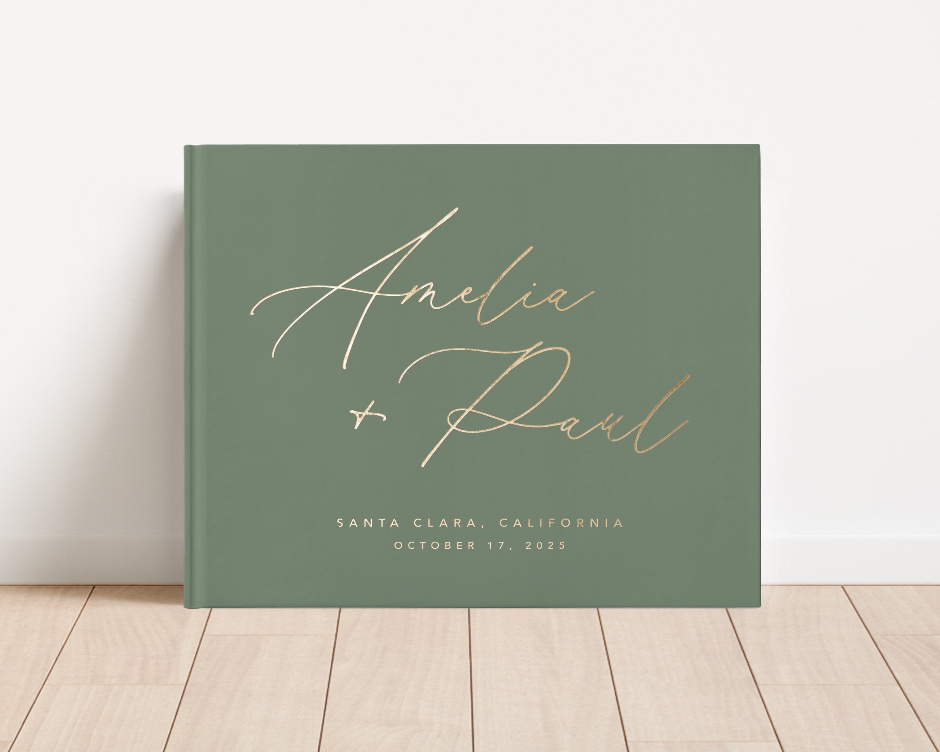 Luxury wedding guest book with custom gold foil text and sage green hardback cover.
