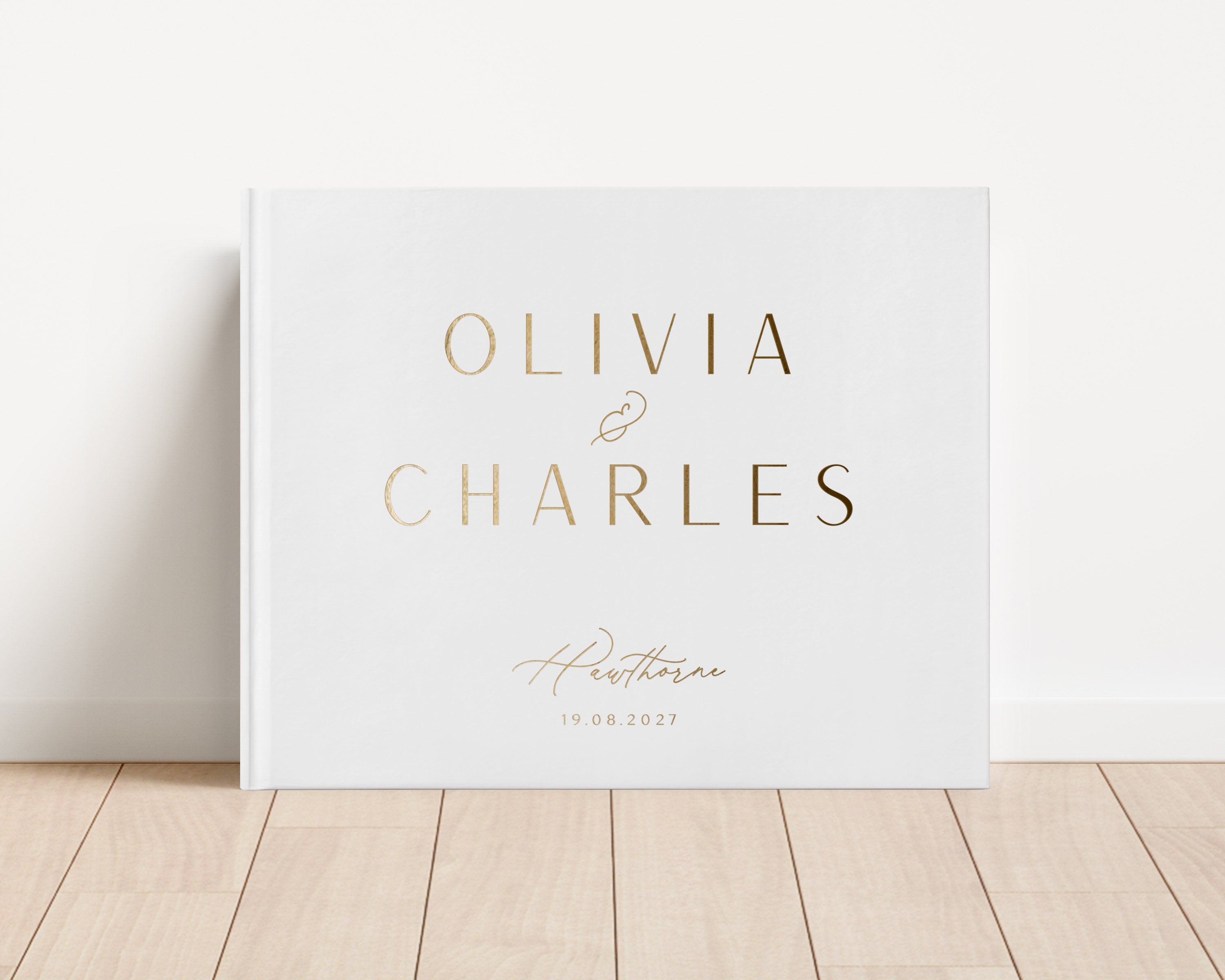 Luxury wedding guest book with custom gold foil text and white hardback cover.